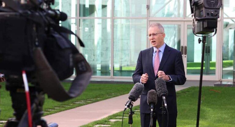 Paul Fletcher speaking at a lectern